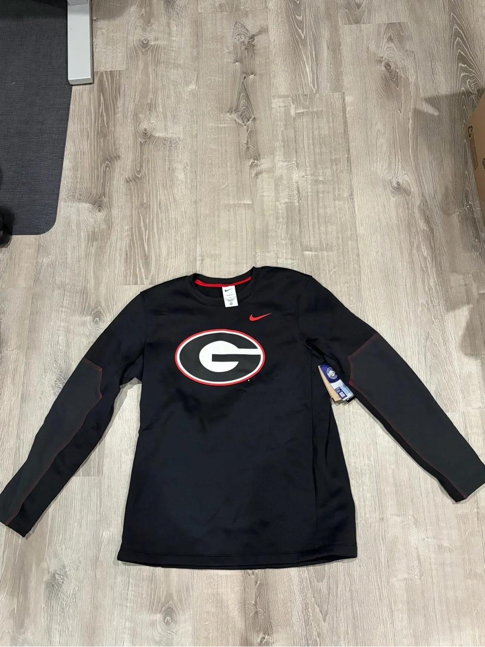 2026 Nike Black Georgia Bulldogs Long-Sleeve Athletic Top with Red Accents